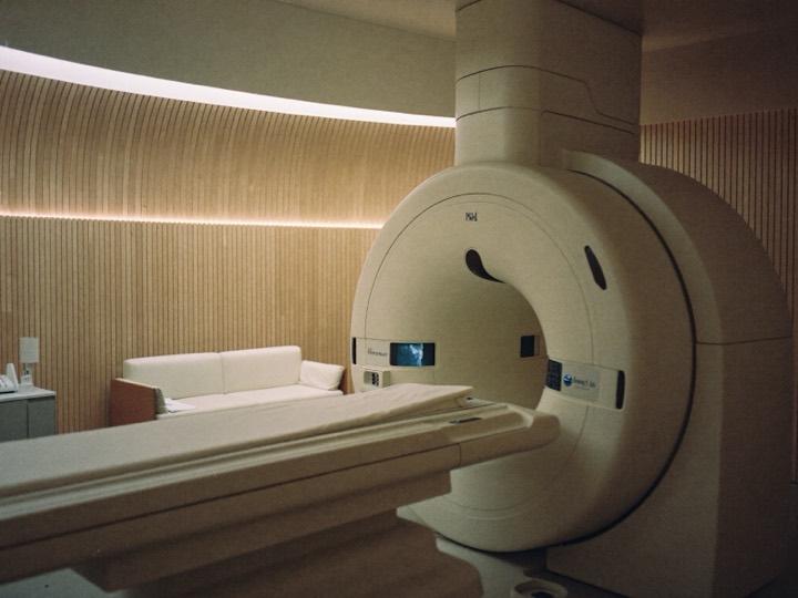 A PET-CT scanner in a wood-panelled imaging suite